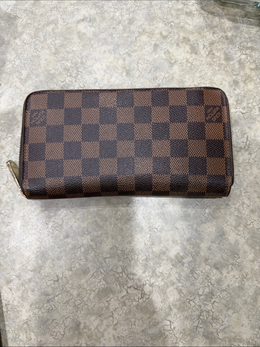 Louis Vuitton Damier Ebene Zippy wallet.